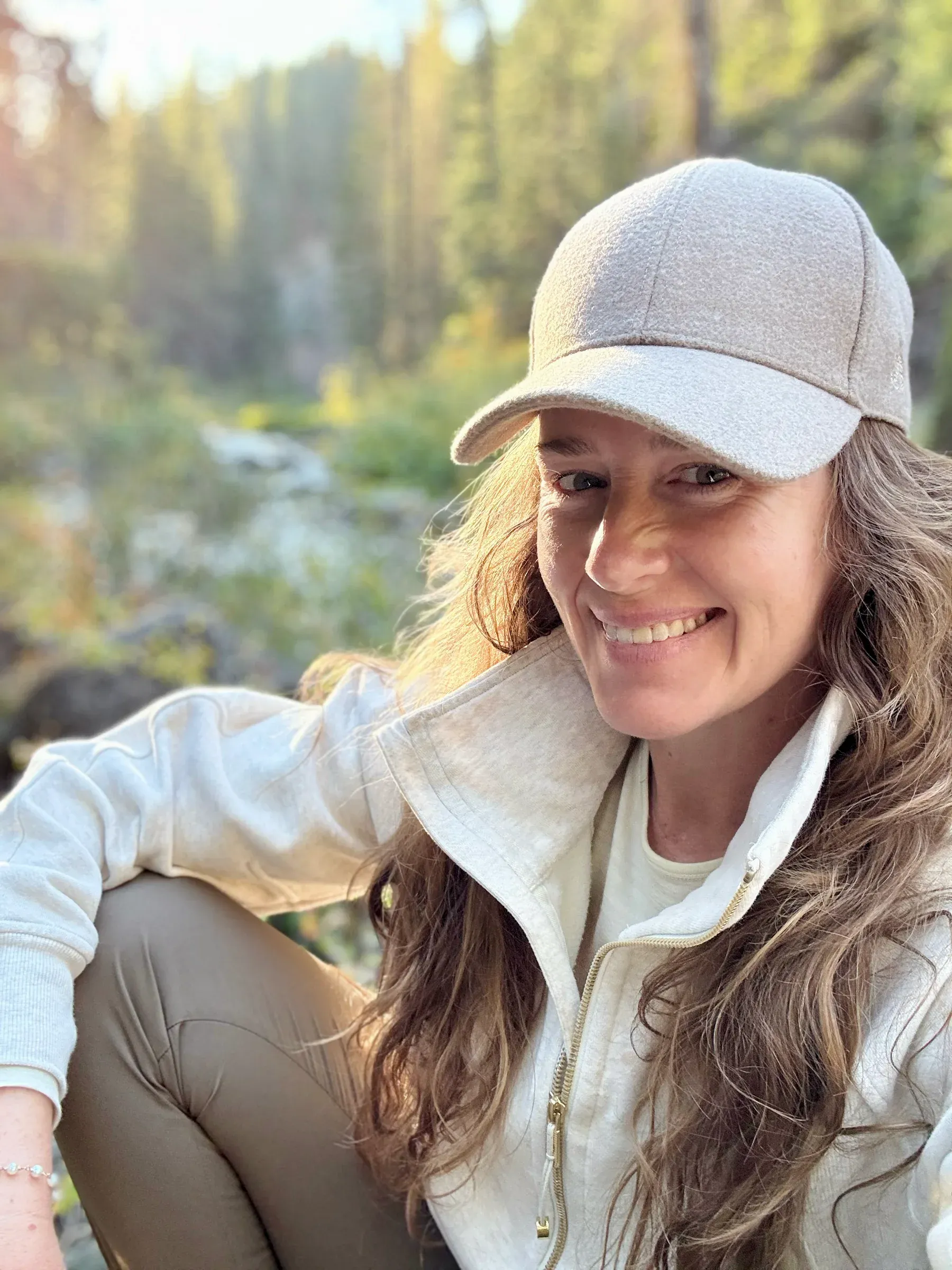 Katie Hamilton outdoors on a forest trail in late afternoon light